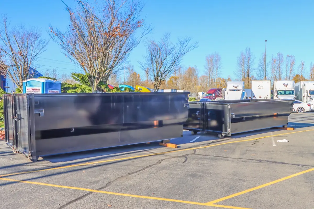 Professional dumpster rental service with roll-off container on residential driveway in Carolina Beach